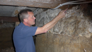 Checking the timbers for rots in a basement