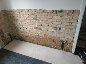 The injected chemical damp proof can clearly be seen at the bottom of the wall.  